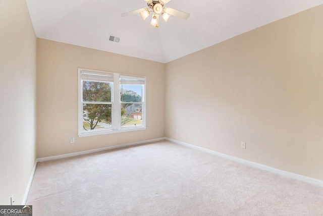 empty room with ceiling fan, light colored carpet, and lofted ceiling