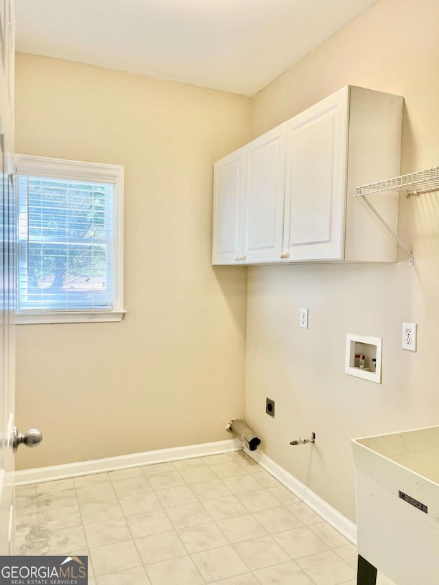 clothes washing area with cabinets, gas dryer hookup, hookup for a washing machine, and electric dryer hookup