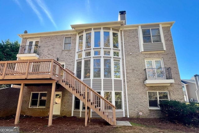 rear view of house with a wooden deck