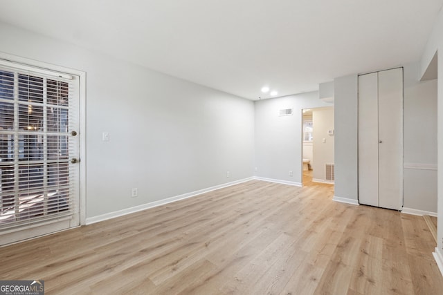 spare room featuring light wood-type flooring