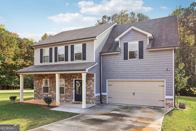 view of front of property with a porch, a garage, and a front lawn