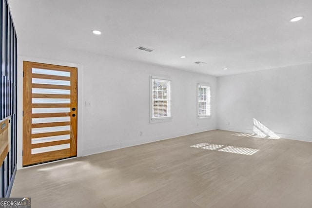 unfurnished room with recessed lighting, visible vents, and wood finished floors