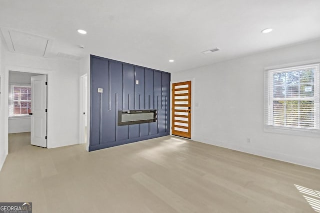 unfurnished living room featuring light wood-type flooring