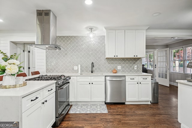 kitchen with white cabinets, dark wood-type flooring, wall chimney exhaust hood, and stainless steel appliances