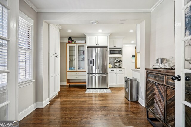 kitchen with white cabinets, tasteful backsplash, stainless steel appliances, and dark wood-type flooring