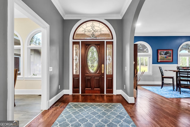 entrance foyer with dark hardwood / wood-style floors and ornamental molding