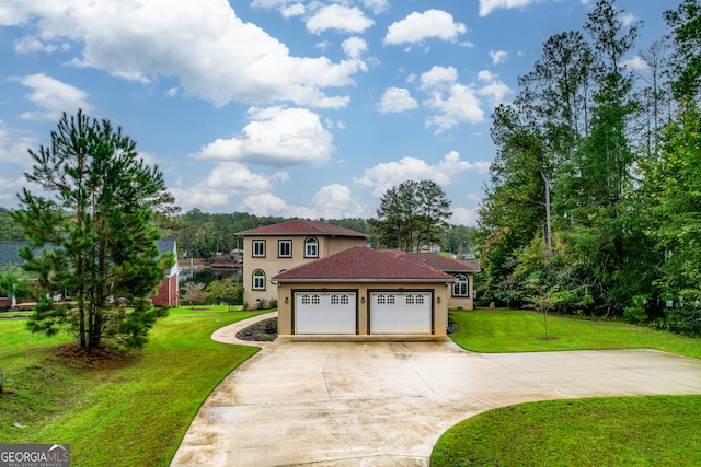 mediterranean / spanish-style home featuring a front lawn and a garage