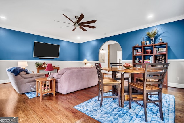 living room with ceiling fan, hardwood / wood-style floors, and ornamental molding