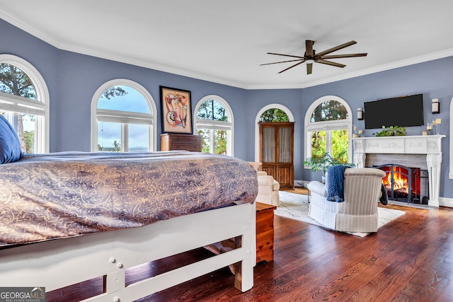 bedroom with hardwood / wood-style flooring, multiple windows, and ceiling fan