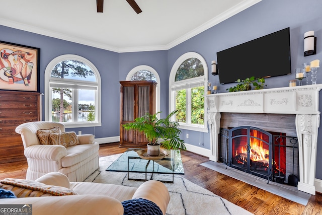 living room with ornamental molding, ceiling fan, and hardwood / wood-style flooring