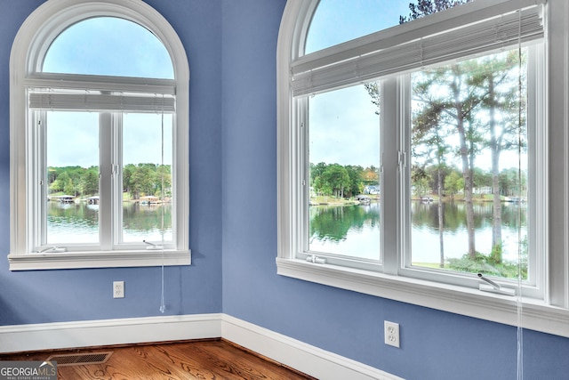 interior details with a water view and hardwood / wood-style flooring