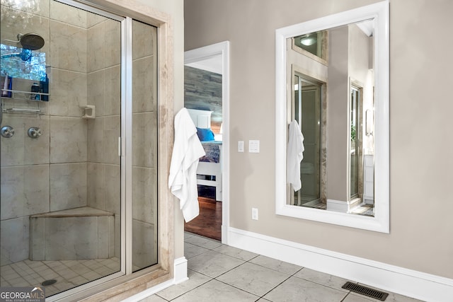 bathroom featuring tiled shower and tile patterned floors