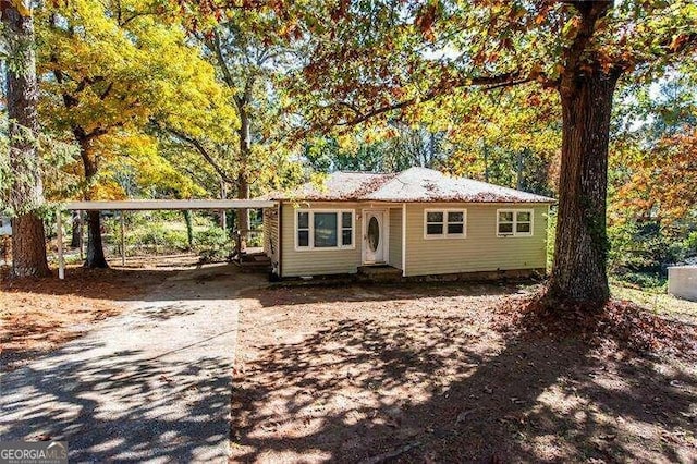 ranch-style house featuring a carport