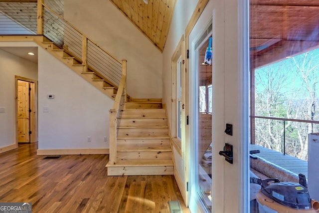 staircase with a wealth of natural light and wood-type flooring