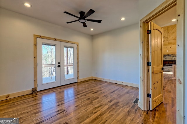 interior space with hardwood / wood-style flooring, ceiling fan, and french doors