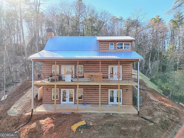 back of house with a patio, french doors, and central AC