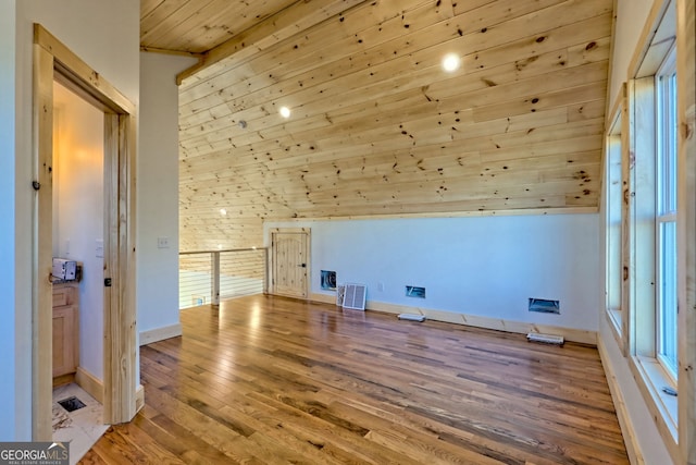 bonus room with hardwood / wood-style flooring and wooden ceiling