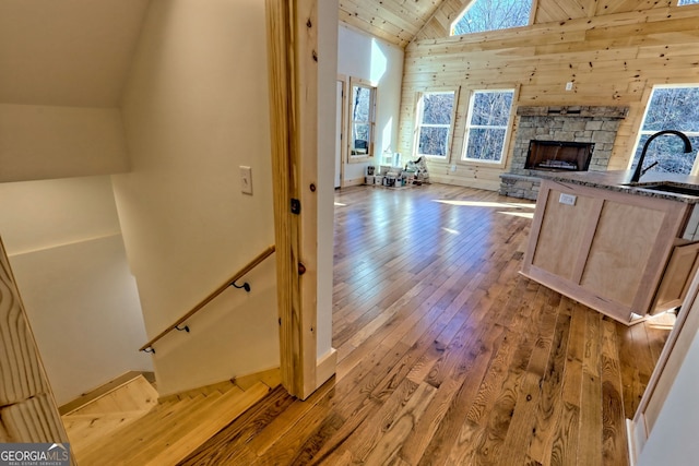 interior space featuring high vaulted ceiling, light hardwood / wood-style flooring, and sink