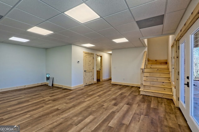 basement with hardwood / wood-style flooring and a paneled ceiling