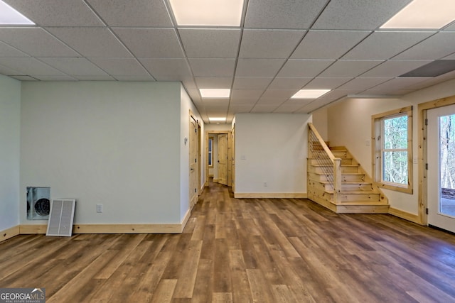 basement featuring hardwood / wood-style floors and a paneled ceiling