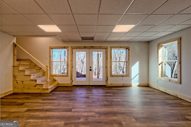 entrance foyer with dark wood-type flooring, a paneled ceiling, and french doors