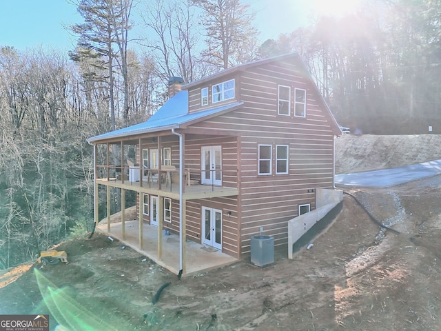 rear view of house with a patio, french doors, and central air condition unit