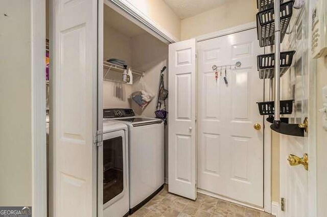 laundry room with washing machine and clothes dryer