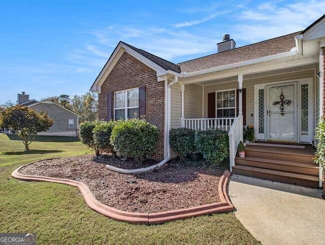 exterior space featuring covered porch and a front yard