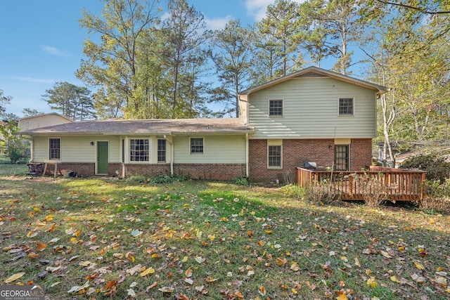 rear view of house with a yard and a deck