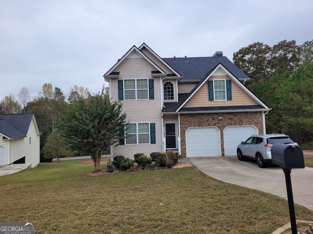 view of front of house featuring a front lawn and a garage