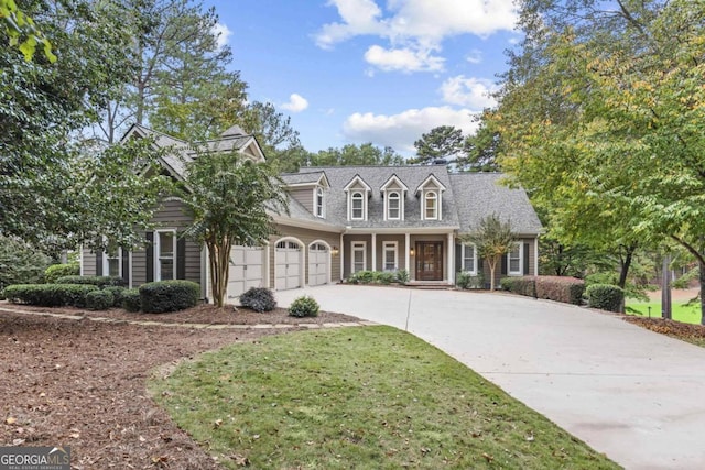 cape cod home with a front lawn and a garage