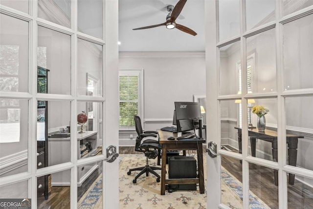 home office with hardwood / wood-style floors and crown molding