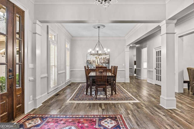 dining area featuring ornate columns, crown molding, dark hardwood / wood-style floors, and an inviting chandelier