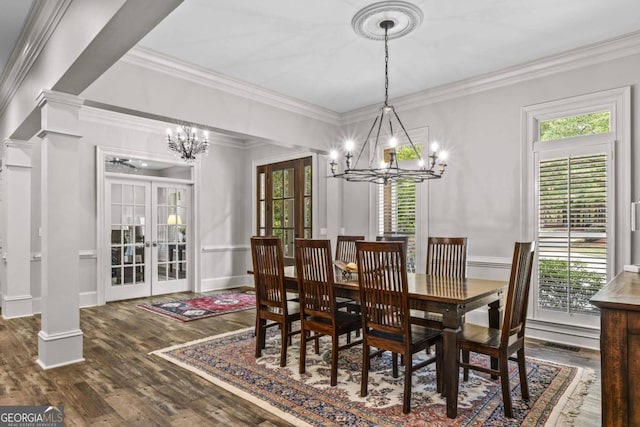 dining area featuring french doors, decorative columns, a healthy amount of sunlight, and wood-type flooring