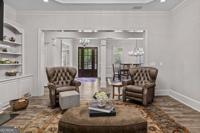 living room with ornamental molding, hardwood / wood-style flooring, and decorative columns