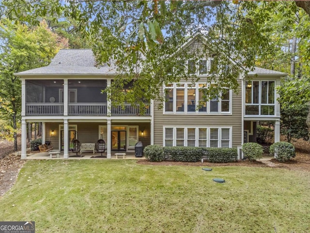 back of house featuring a patio area, a sunroom, and a yard