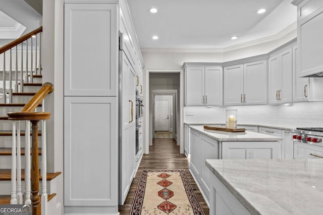 kitchen with decorative backsplash, white cabinetry, crown molding, and light stone countertops