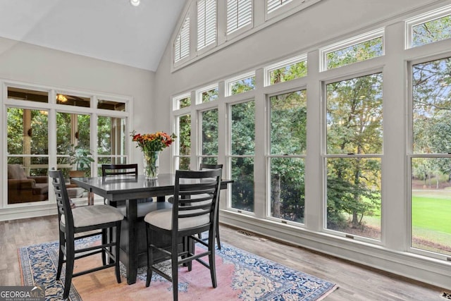 sunroom featuring vaulted ceiling