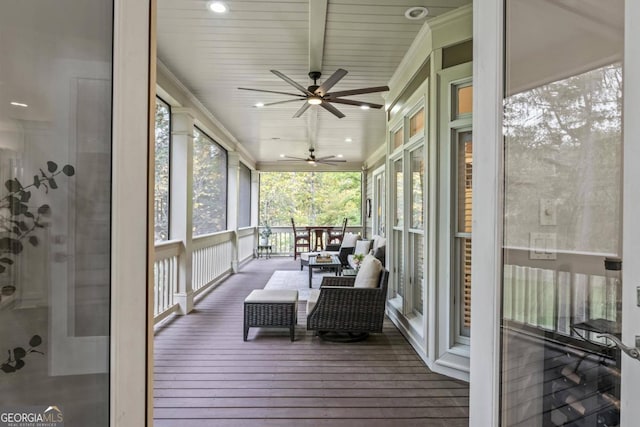 sunroom / solarium featuring ceiling fan