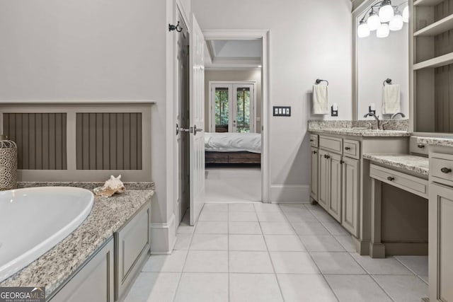 bathroom featuring tile patterned flooring, built in shelves, and vanity