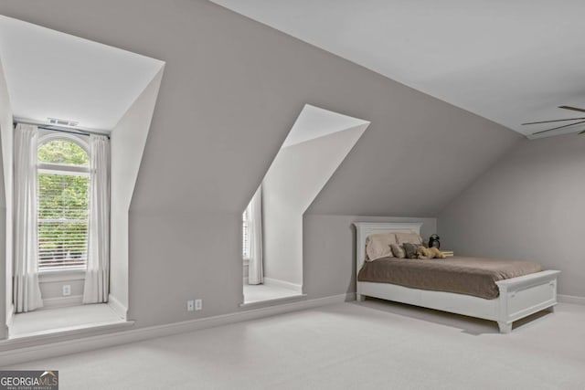 carpeted bedroom with lofted ceiling