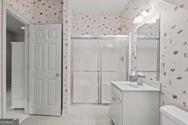 bathroom featuring toilet, vanity, tile patterned floors, and walk in shower