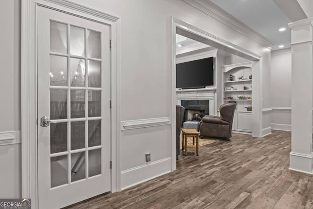 interior space featuring ornate columns, crown molding, and wood-type flooring