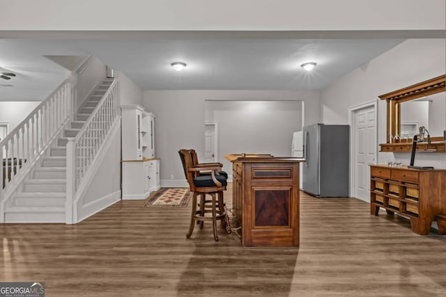 dining room featuring dark hardwood / wood-style flooring and bar area