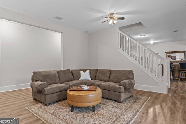 living room with hardwood / wood-style flooring and ceiling fan