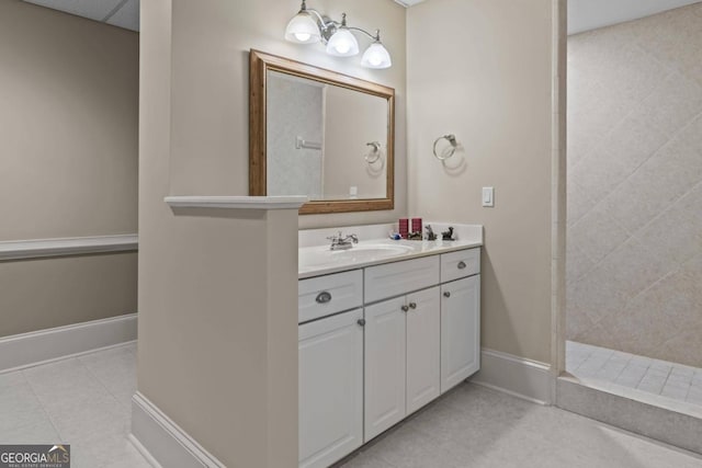 bathroom featuring vanity, tiled shower, and tile patterned floors