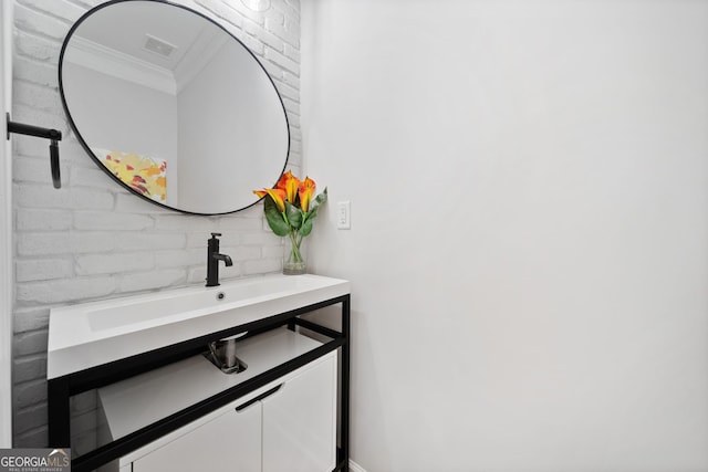 bathroom featuring crown molding and vanity