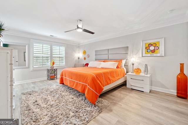 bedroom with ornamental molding, light wood-type flooring, and ceiling fan