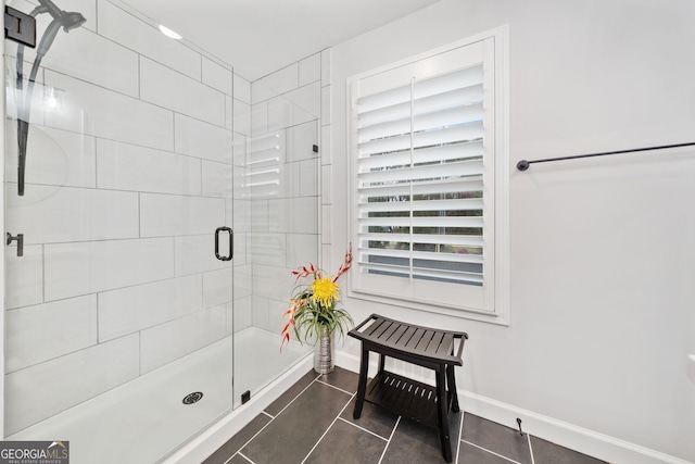 bathroom featuring tile patterned flooring and a shower with shower door