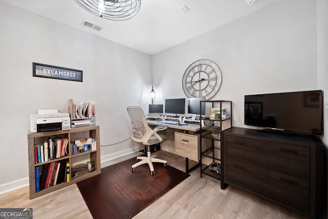 office space with light hardwood / wood-style floors